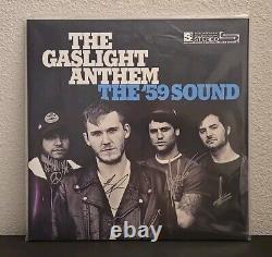 Le Gaslight Anthem a signé l'album vinyle The'59 Sound, autographié en bleu, rare.